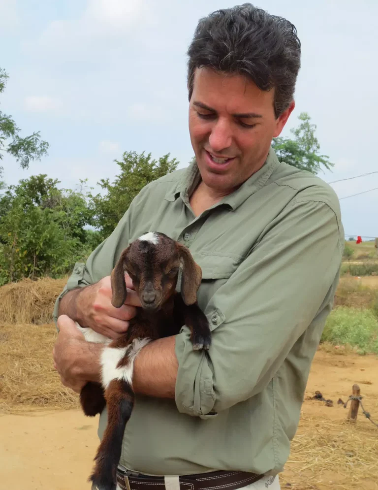 Wayne Pacelle with baby goat in pradesh village.